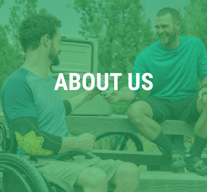 two men in wheelchairs sharing a drink