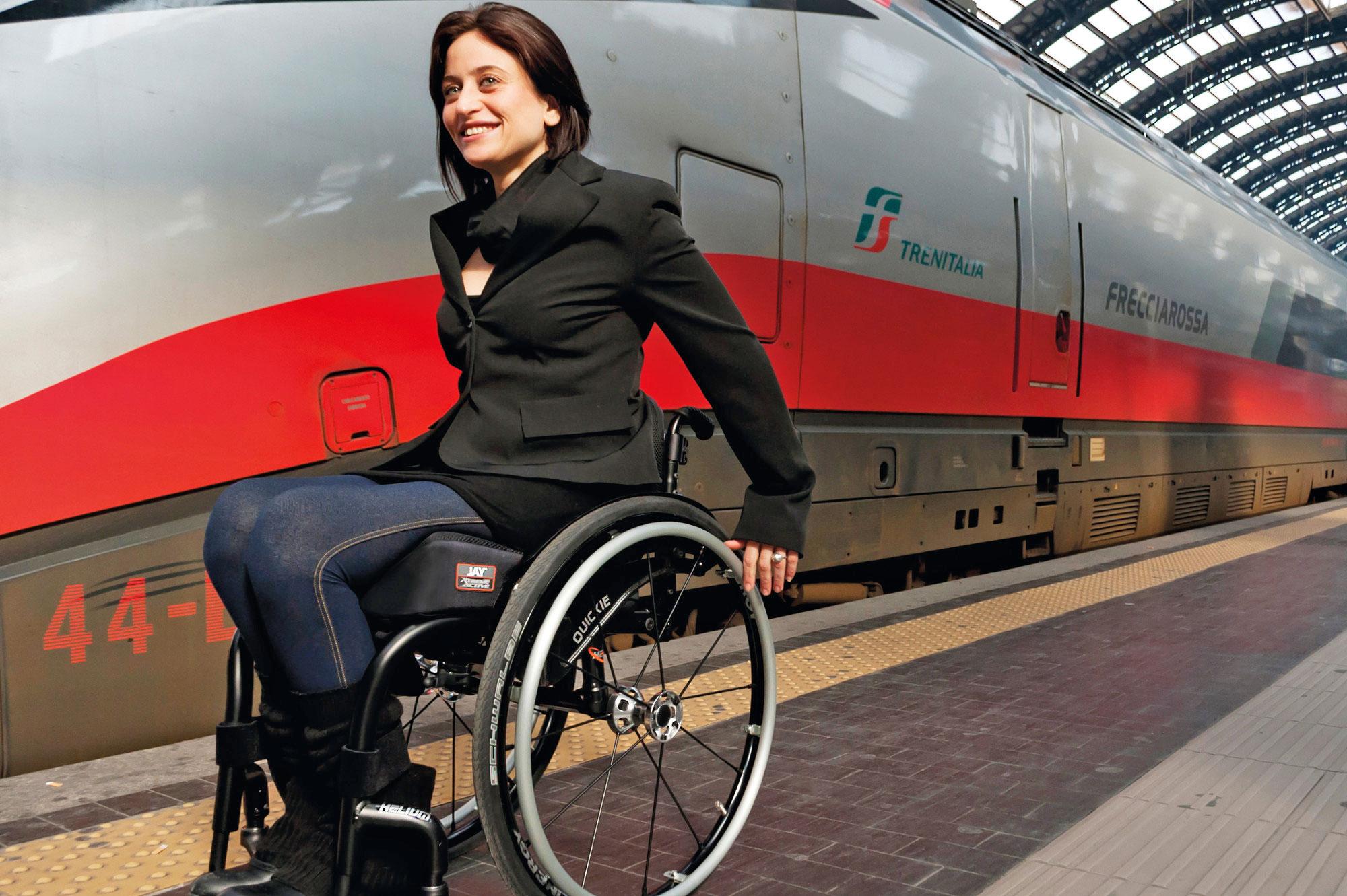 woman getting off a train on a wheelchair